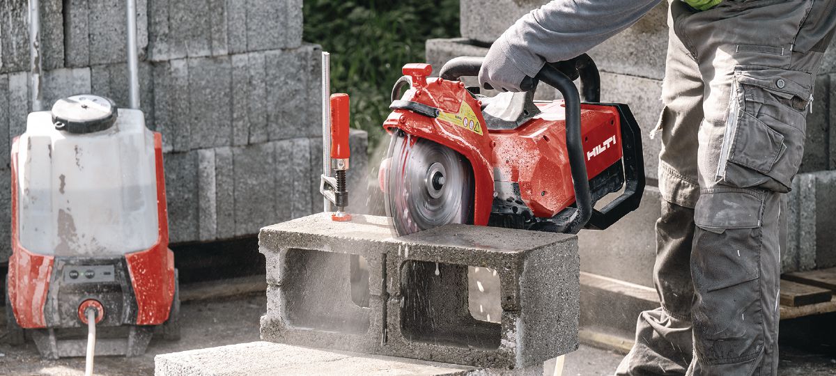 hilti 2 Worker using a red Hilti disc cutter to cut concrete blocks on a work site